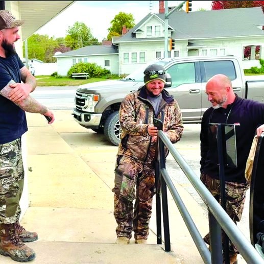 Out-of-state deer hunters Nick Mihelcic, Dan Mihelcic, and Ryan Rayburn exchanged stories about their Pike County hunting experiences outside the Pittsfield Subway restaurant on Sunday morning. The Mihelcic brothers are visiting from metro Pittsburgh, and Rayburn is visiting from Florida. (David Camphouse/River County News) 