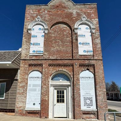 This 1872 brick building is for sale on the Greenfield Square. The Greenfield Revitalization Project has spent two years making improvements to the building and now it is up for sale to a private investor to complete. Proceeds from the sale of the building will be used for the demolition of the green building on the opposite end of the square next to the library. (Carmen Ensinger/River County News) 