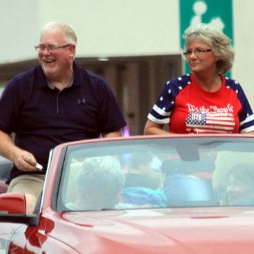 Rob and Mona McMillen lead off the 87th Annual White Hall Lions Club Homecoming Parade Friday evening. Mother Nature took exception for the parade and held off on the rain, which had been sporadic all day, until the parade, which lasted more than an hour, was over. (Carmen Ensinger/River County News)